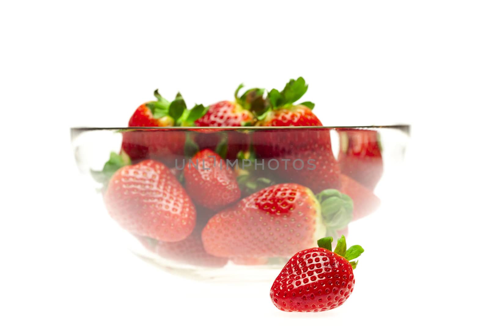 juicy strawberries in a bowl isolated on white by jannyjus