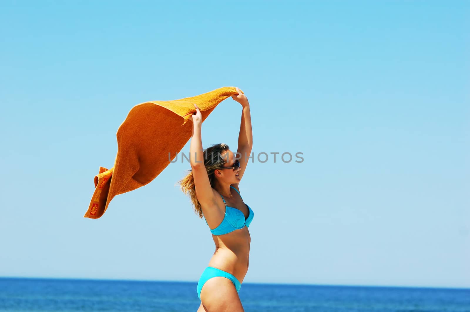 Young attractive woman enjoying summertime on the beach