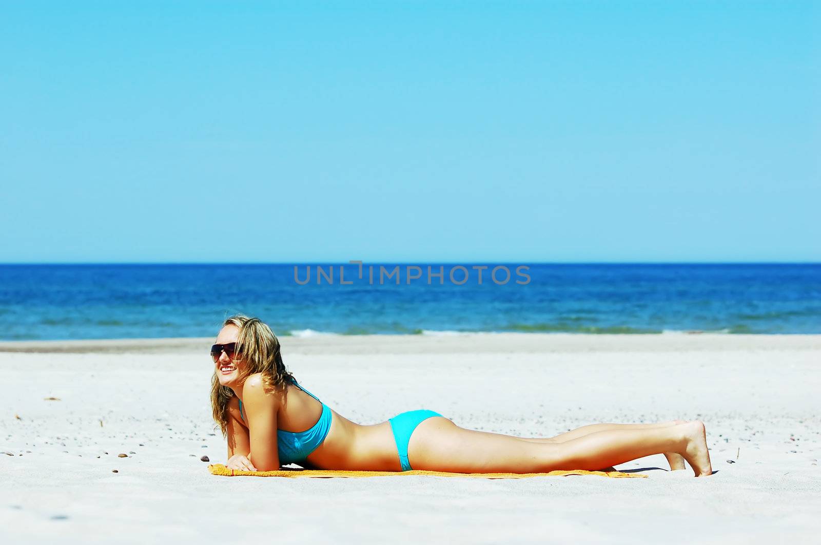 Beautiful woman relaxing on the beach. Lots of useful copyspace