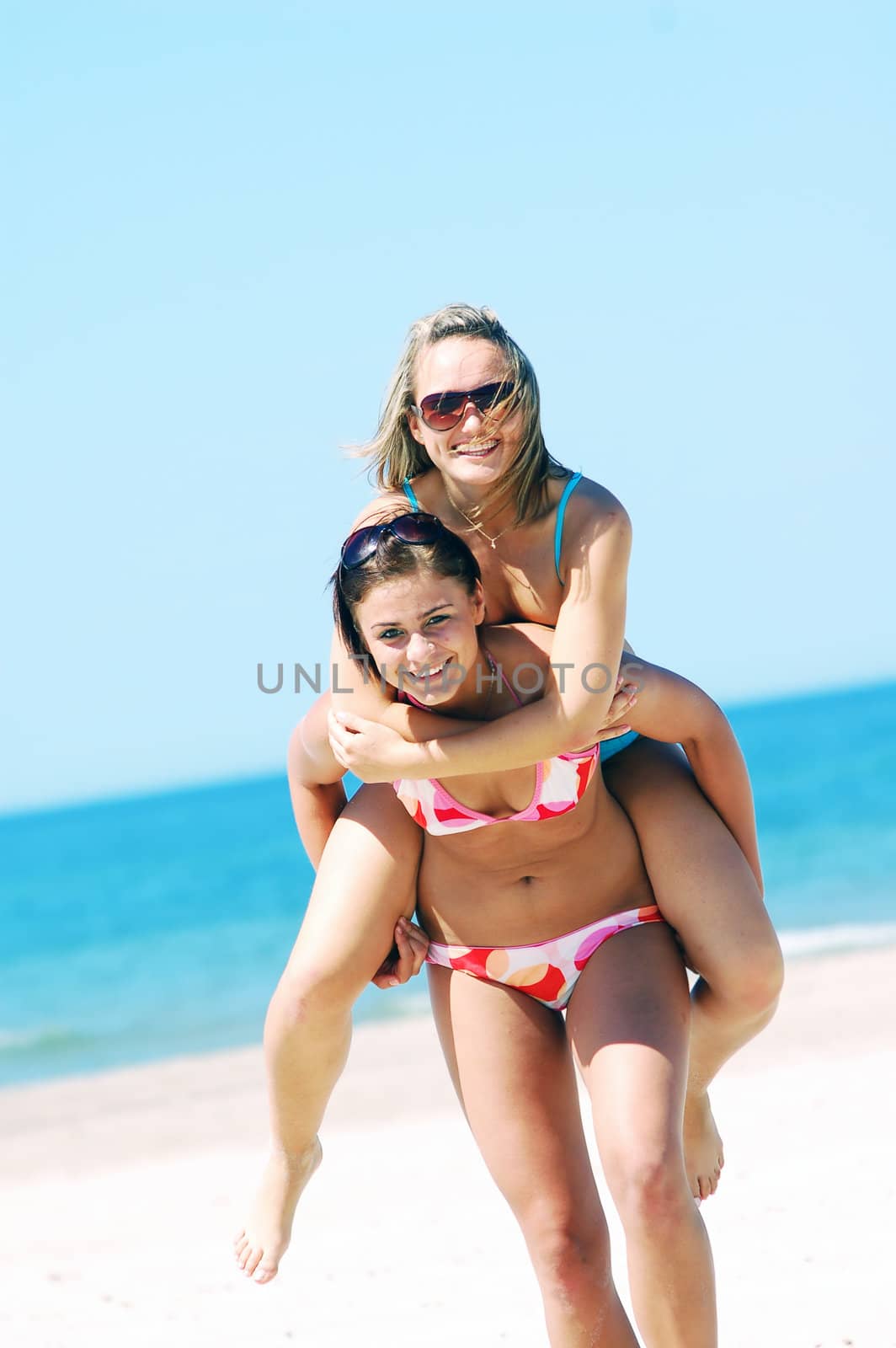 Young women on the summer beach by photocreo