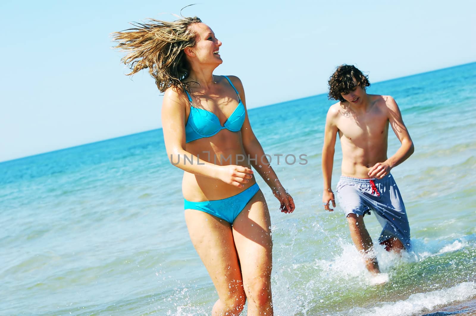 Young attractive friends having fun the summer beach