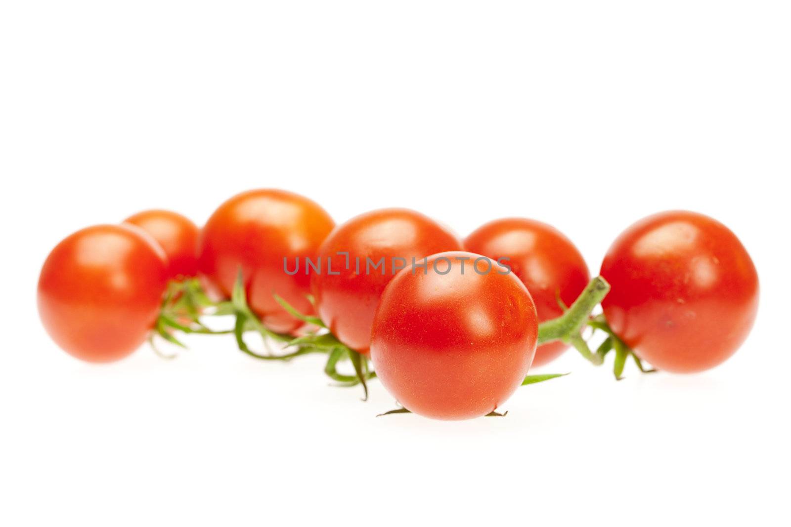 juicy tomatoes isolated on white by jannyjus