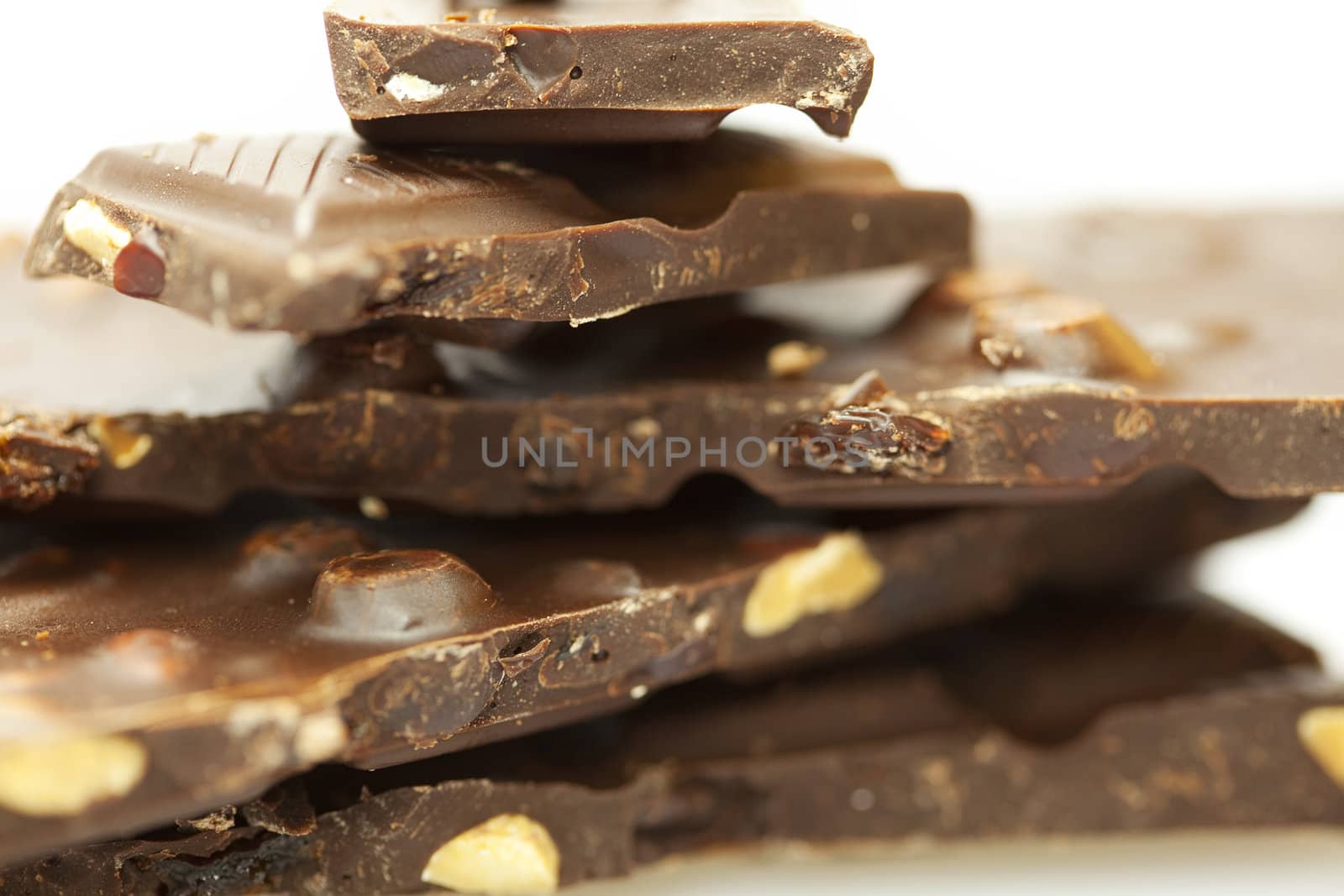 stacks of pieces of chocolate isolated on white