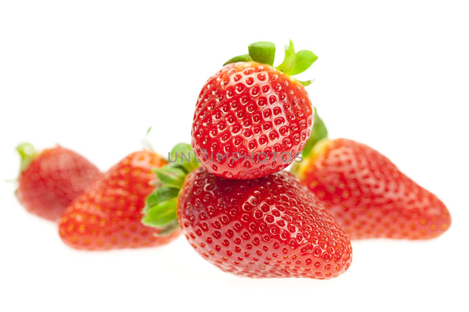 juicy strawberries isolated on white by jannyjus
