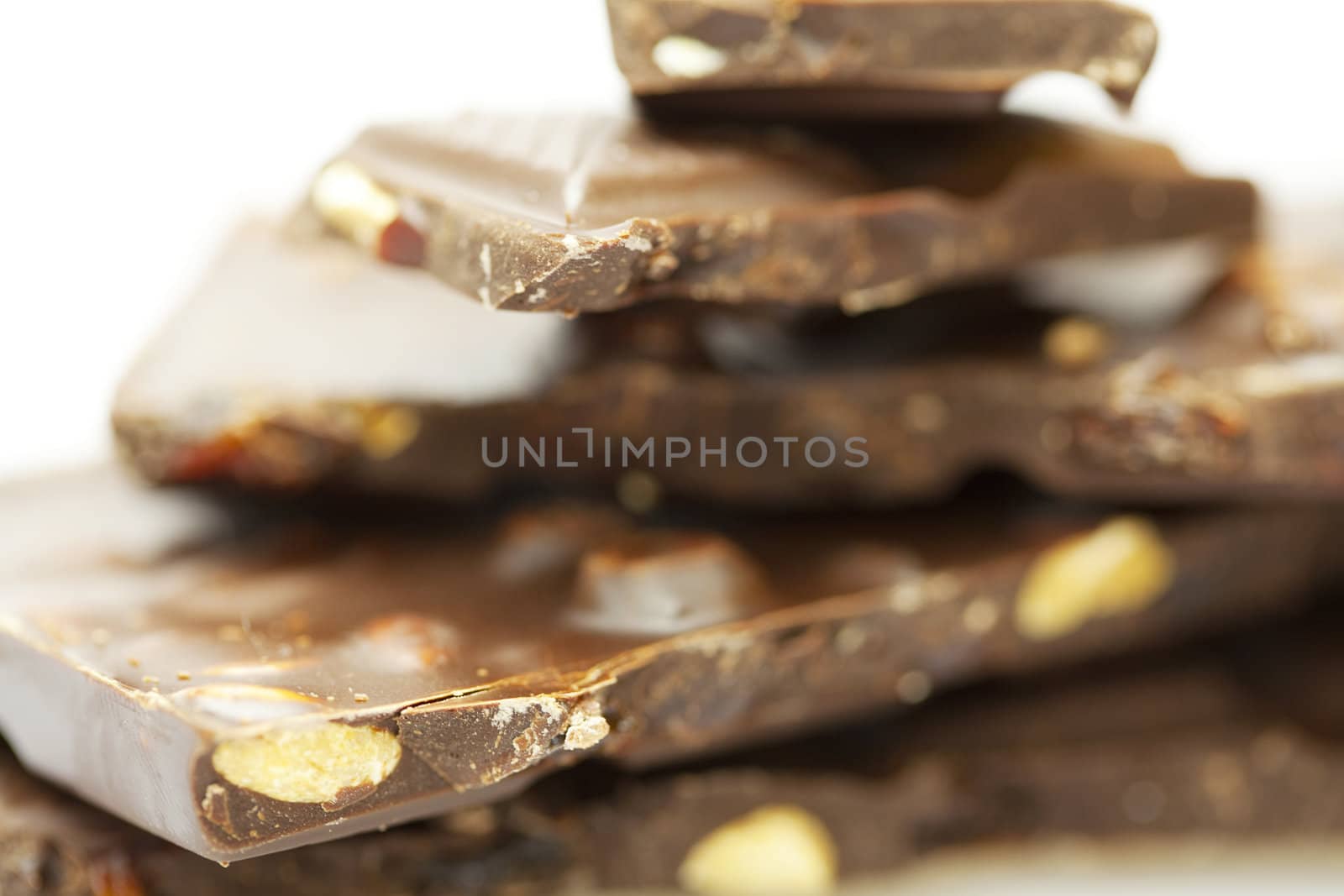 stacks of pieces of chocolate isolated on white by jannyjus