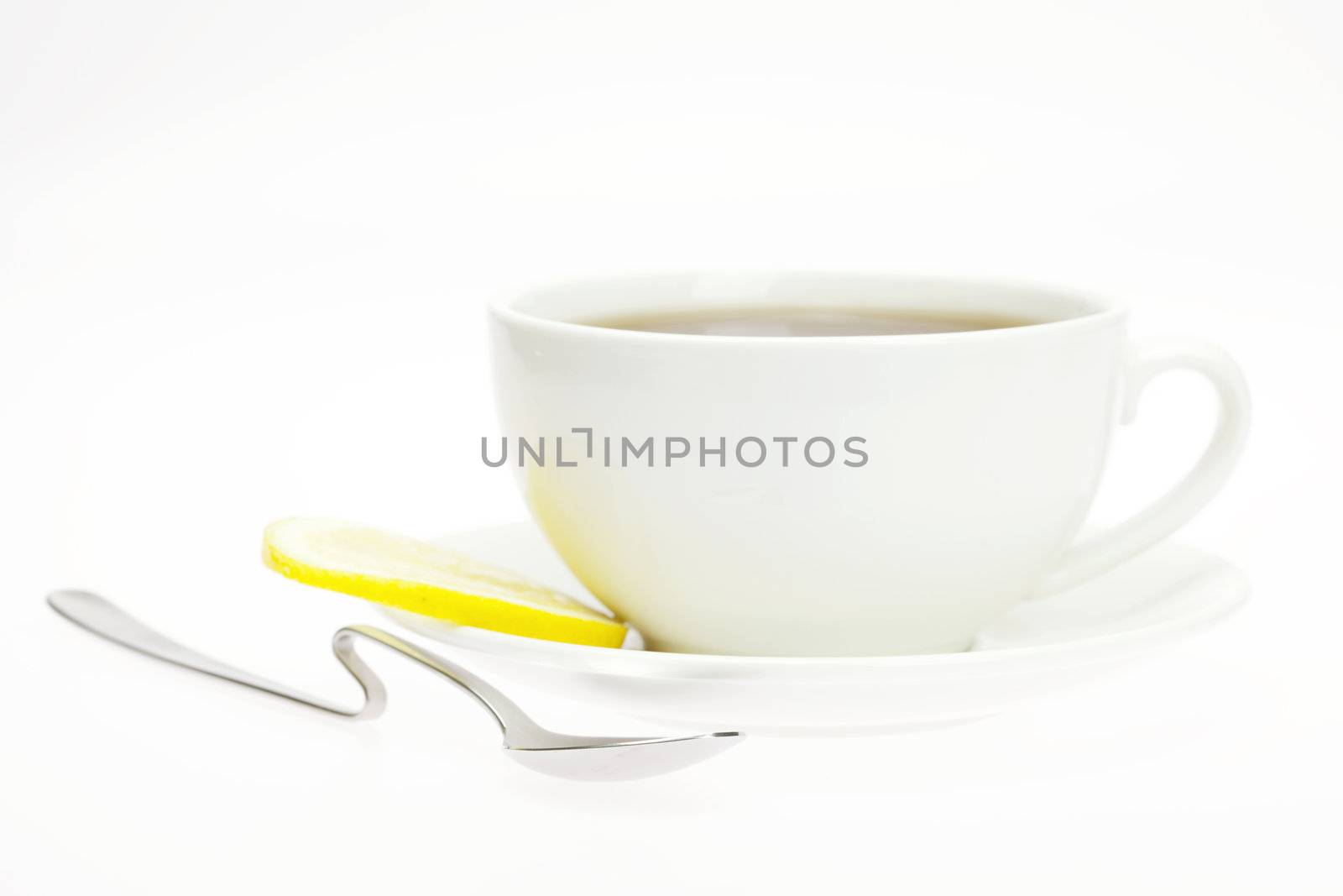 cup and lemon isolated on white by jannyjus