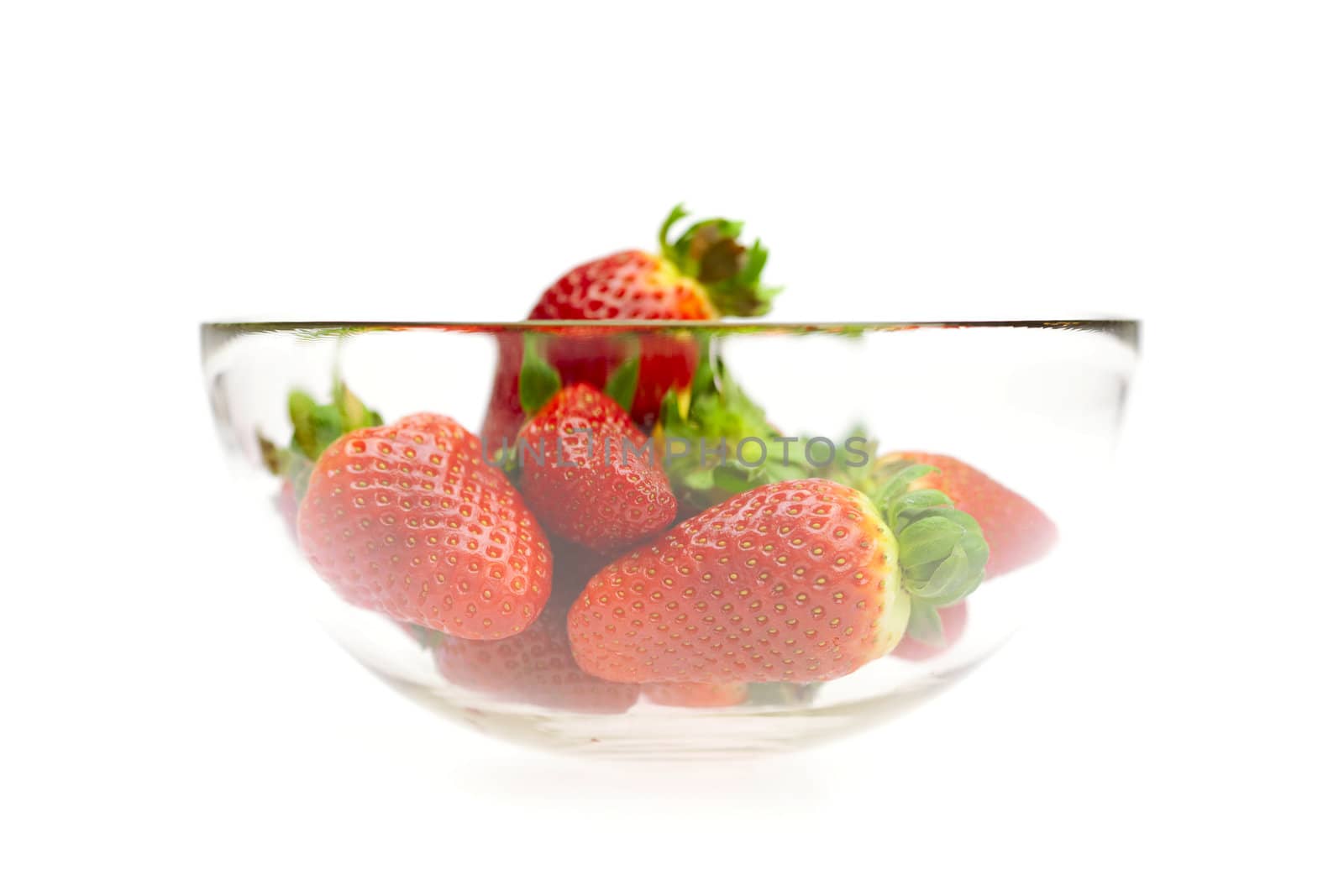 juicy strawberries in a bowl isolated on white by jannyjus