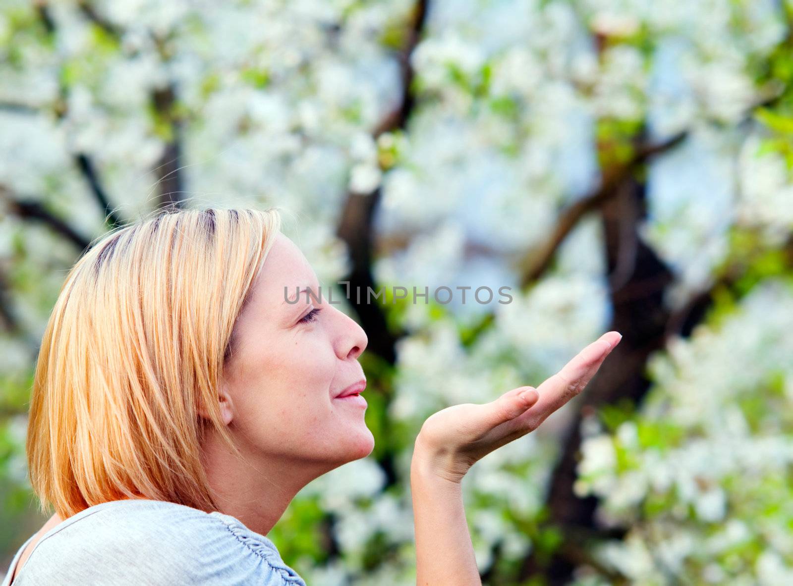 Smiling blonde woman enjoying spring