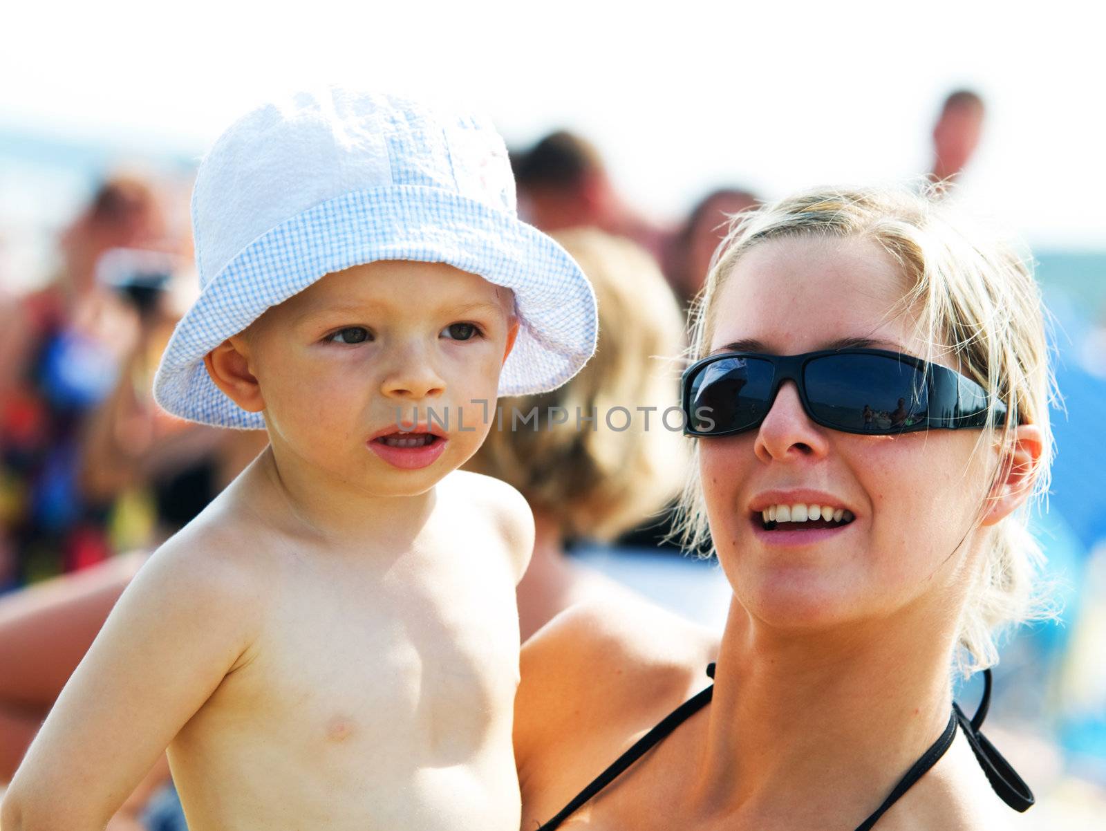 Mother with a baby on the beach