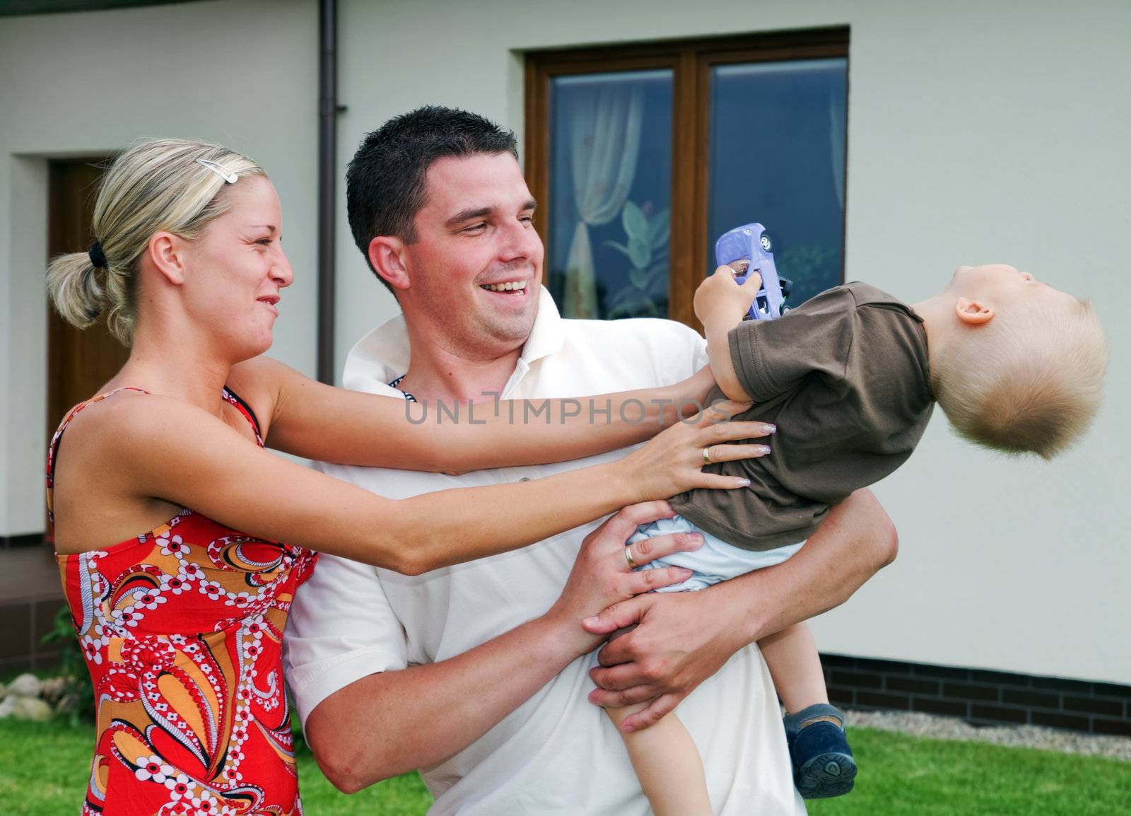 Happy family in front of their house