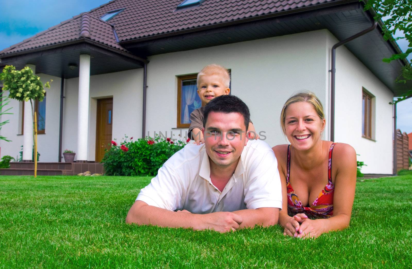 Happy family in front of their house