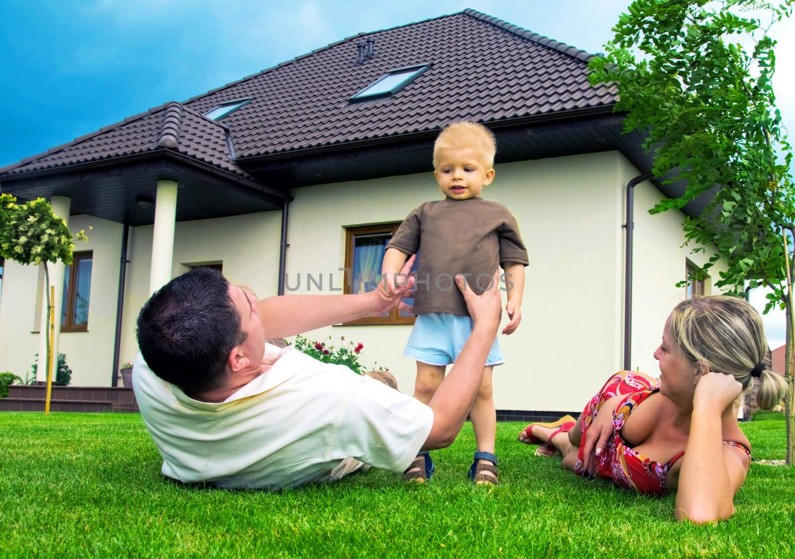 Happy family in front of their house