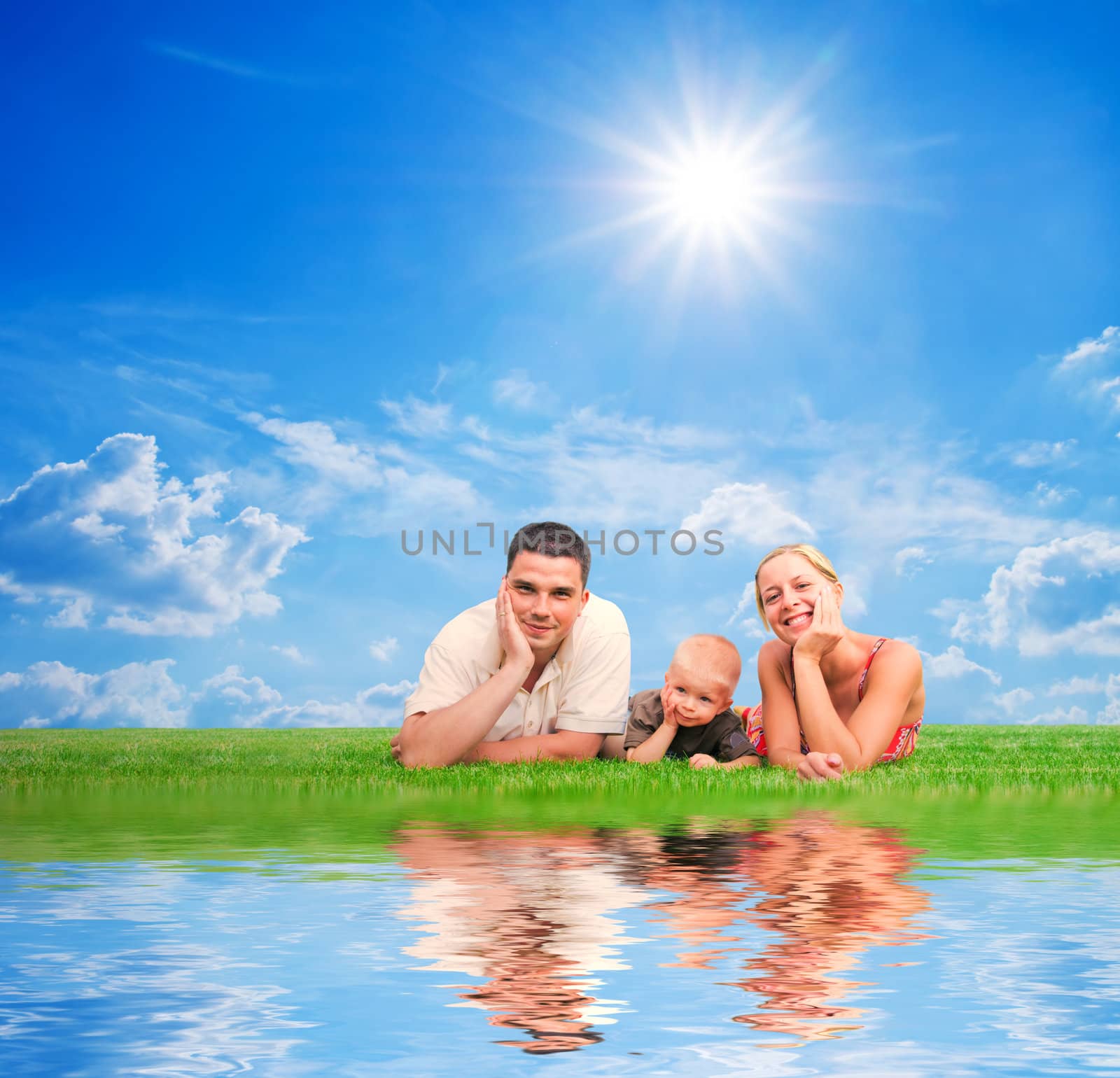 Happy family on grass, sunny sky. Mother, father and a child.