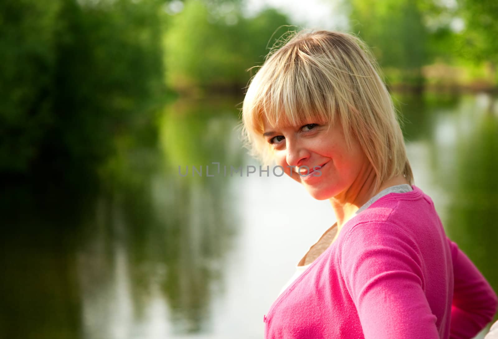 Young woman portrait on nature background in summer