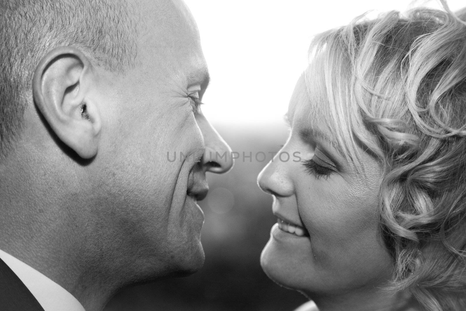 Happy bride and groom kissing. Black and white