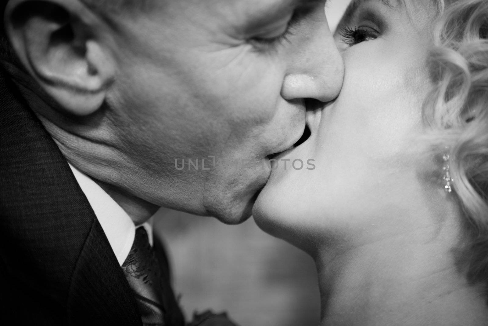 Happy bride and groom kissing. Black and white