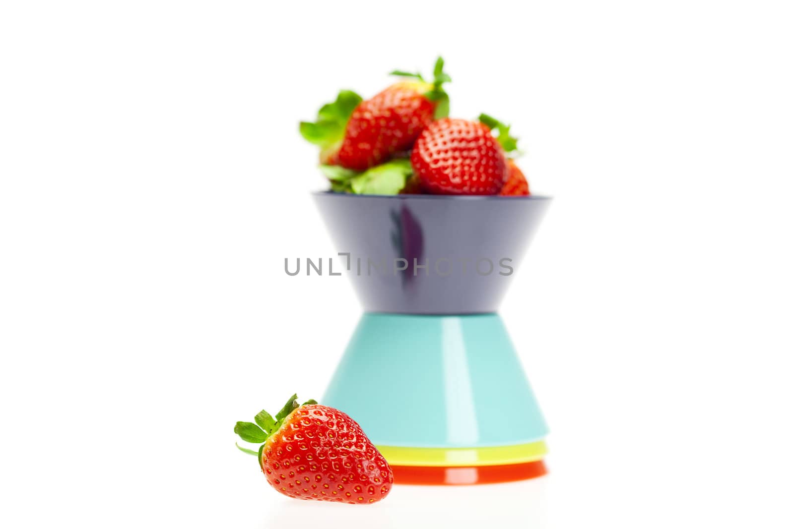 juicy strawberries in a bowl isolated on white