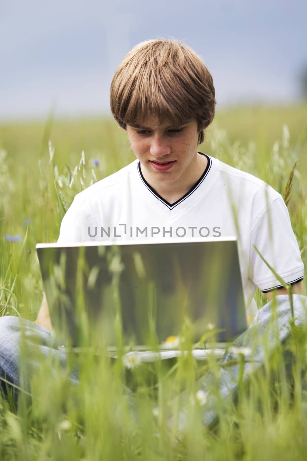 Boy with notebook on the field by photocreo