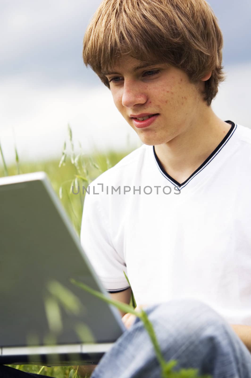 Boy with notebook on the field by photocreo