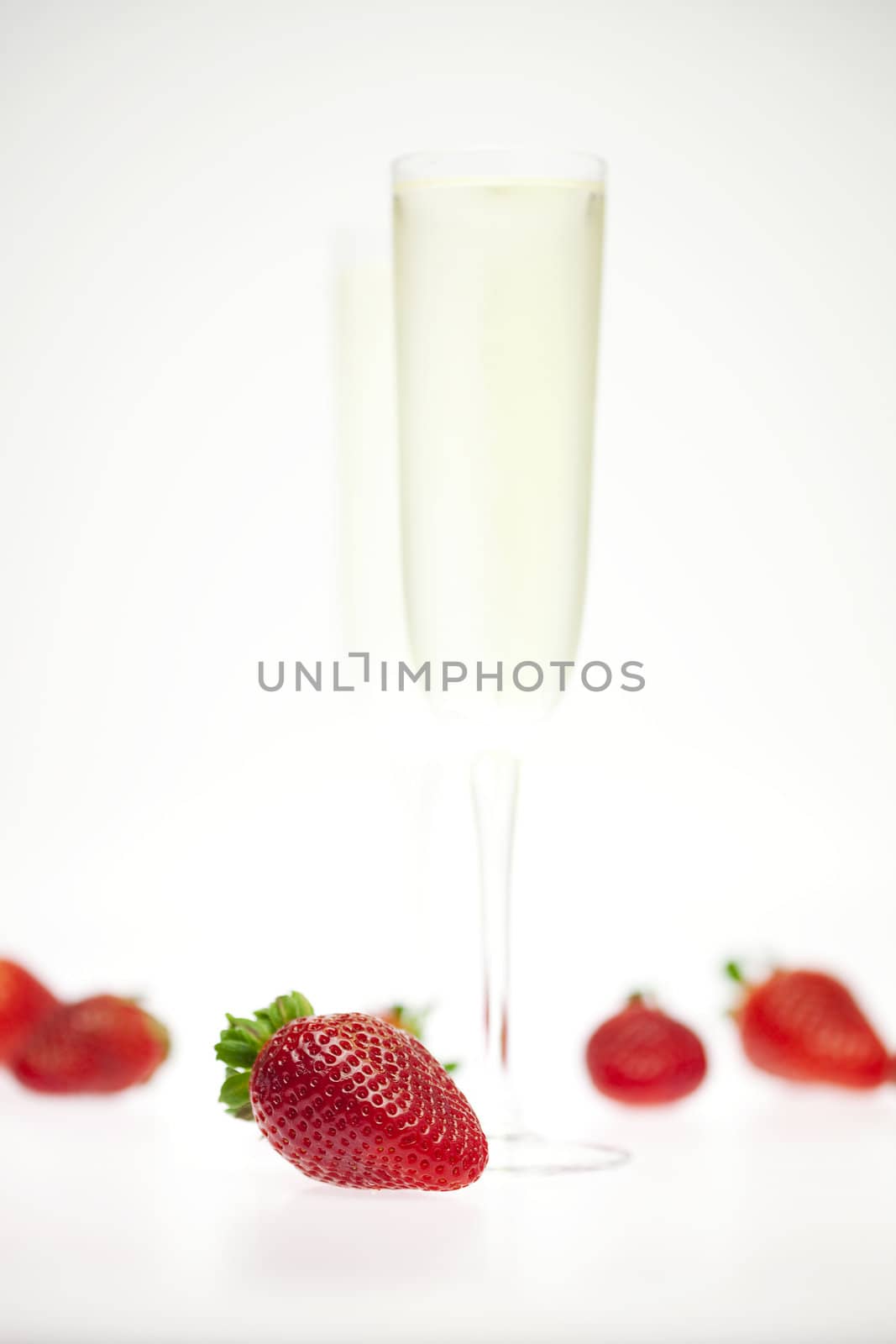 juicy strawberries and champagne glass isolated on white by jannyjus