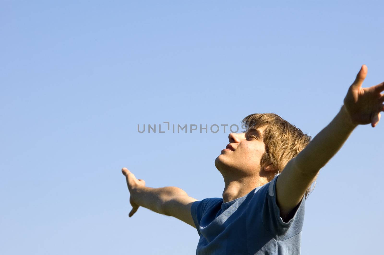 In tune with nature. Young boy showing happiness