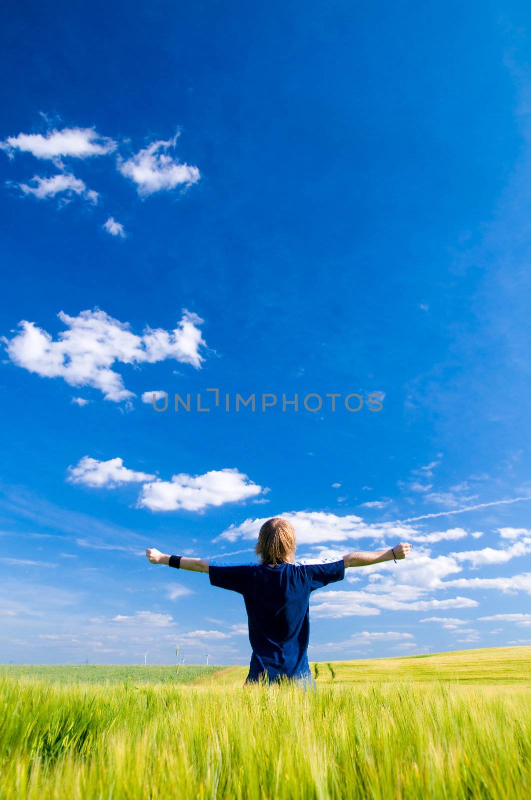 Happy man with arms up by photocreo