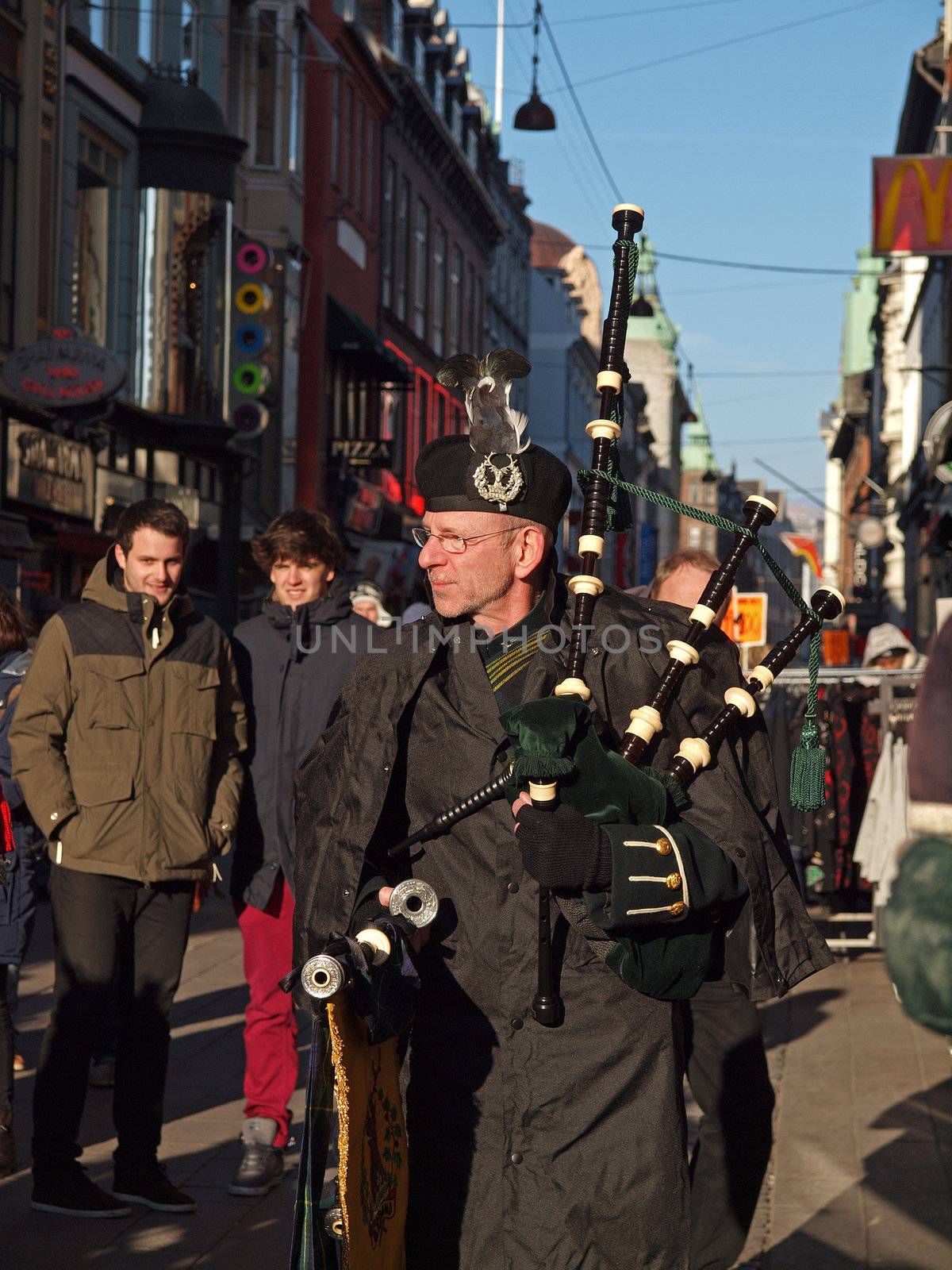COPENHAGEN - MAR 17: Bagpiper at the annual St. Patrick's Day celebration and parade in front of Copenhagen City Hall, Denmark on March 17, 2013.
