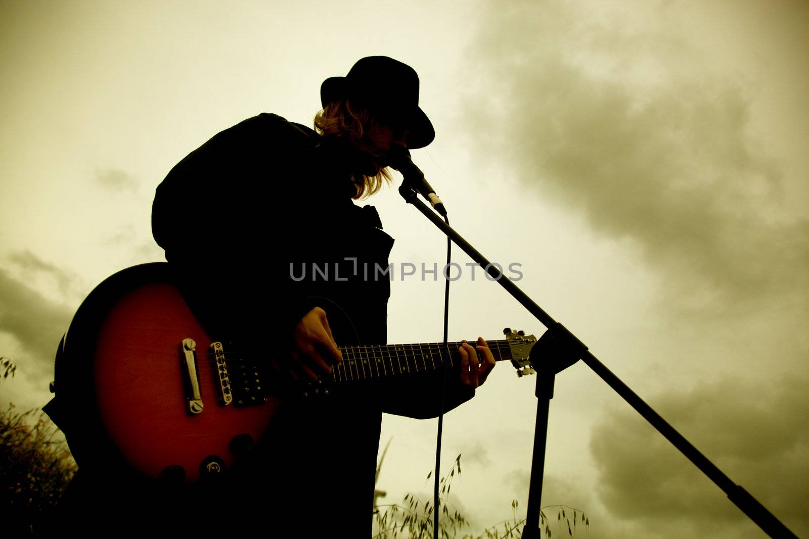 Man playing guitar outdoors. Sepia mood