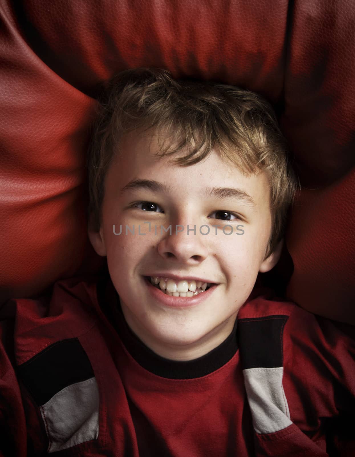 Portrait of happy young boy by photocreo