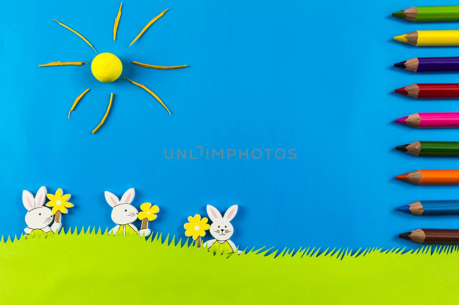 Easter bunnies  playing on grass on blue background