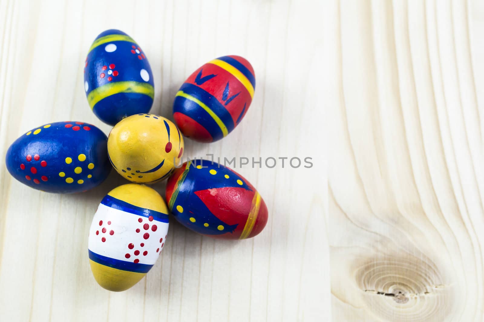 Easter colored eggs on wooden background