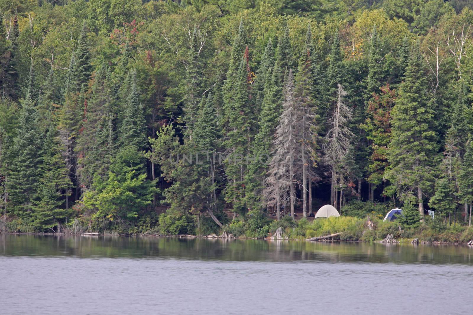 A campsite sitting in on the edge of a lake in Algonquin Provincial Park in Ontario, Canada.
