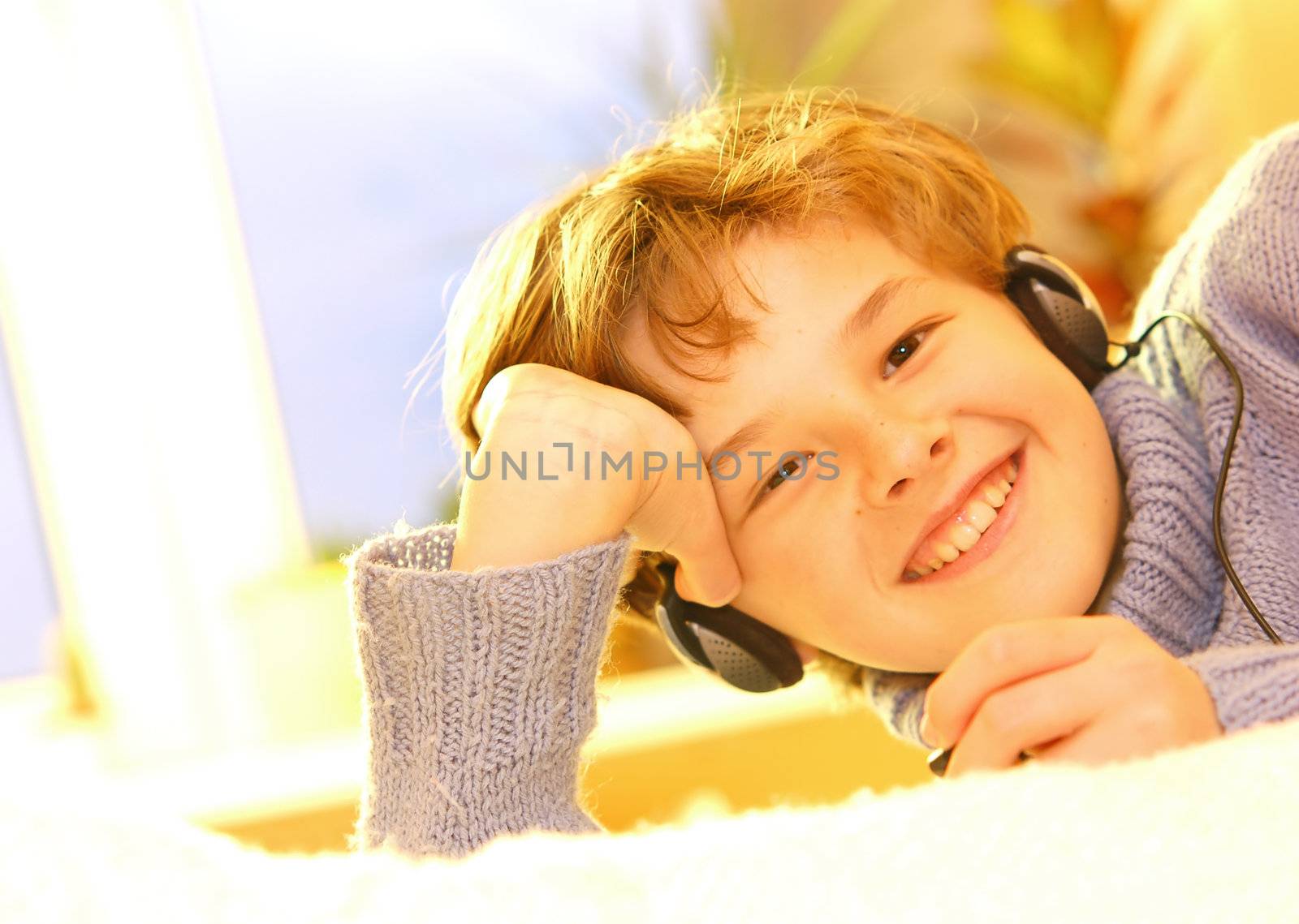 Boy listen to music in warm sunny bedroom