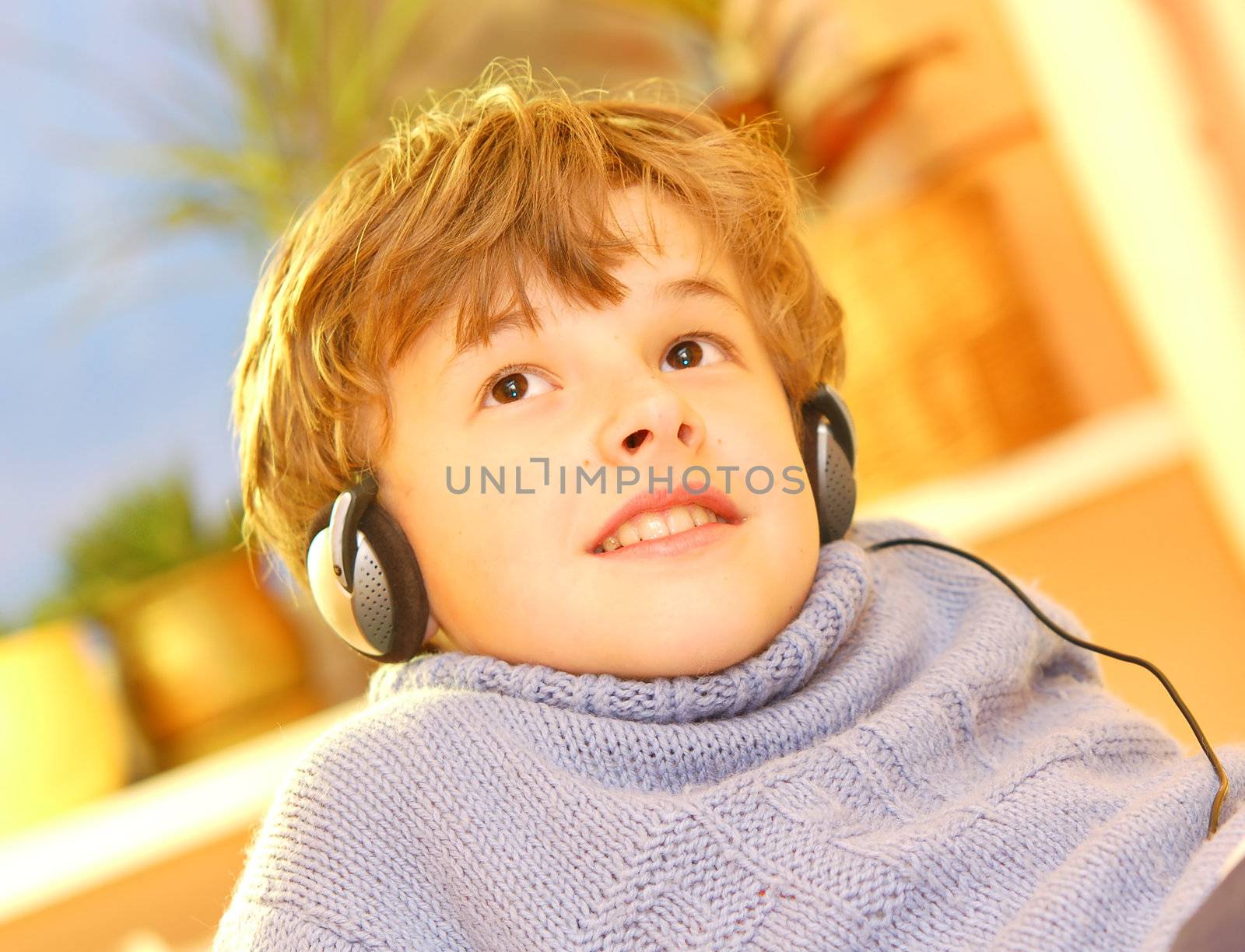 Boy listen to music in warm sunny bedroom