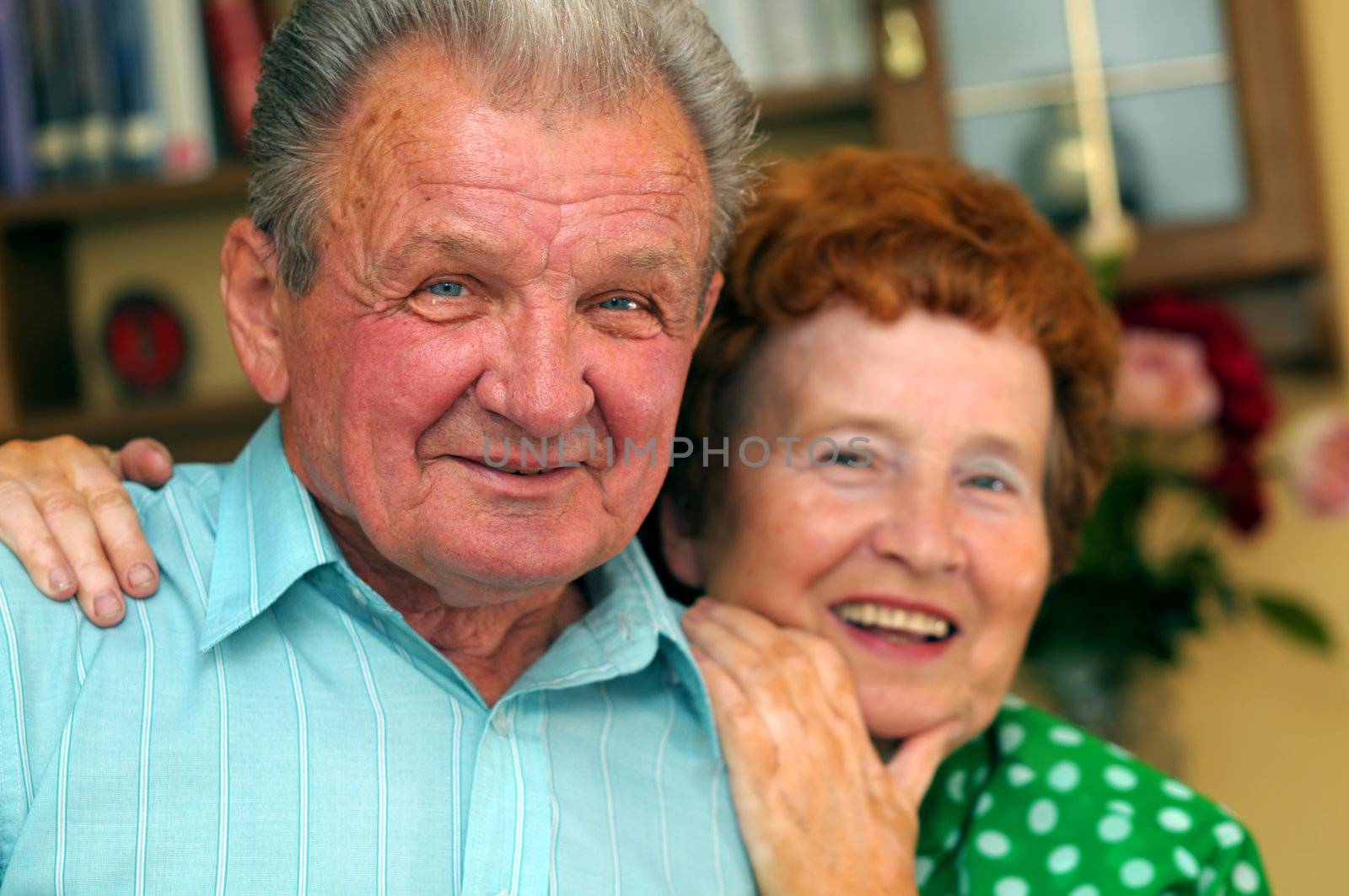 Elderly happy couple in a room
