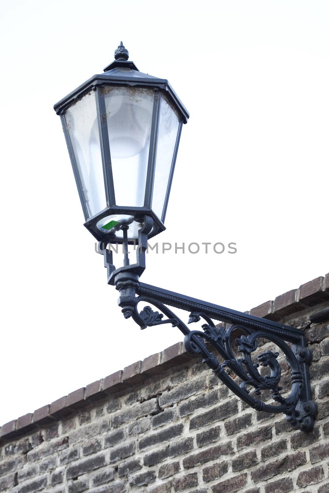 old lantern on a brick wall by jannyjus