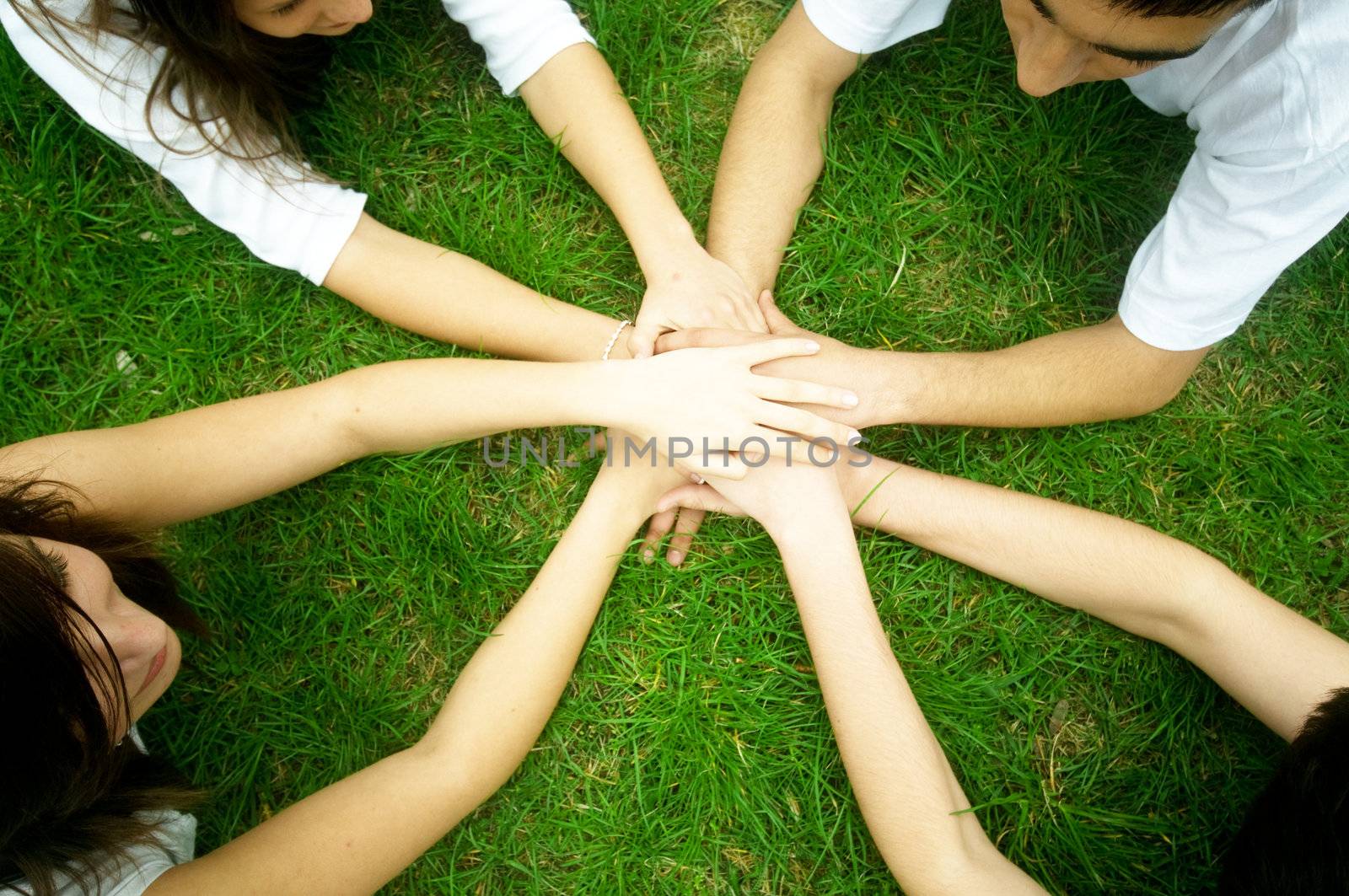 Group of friends joining hands. Unity, teamwork concept