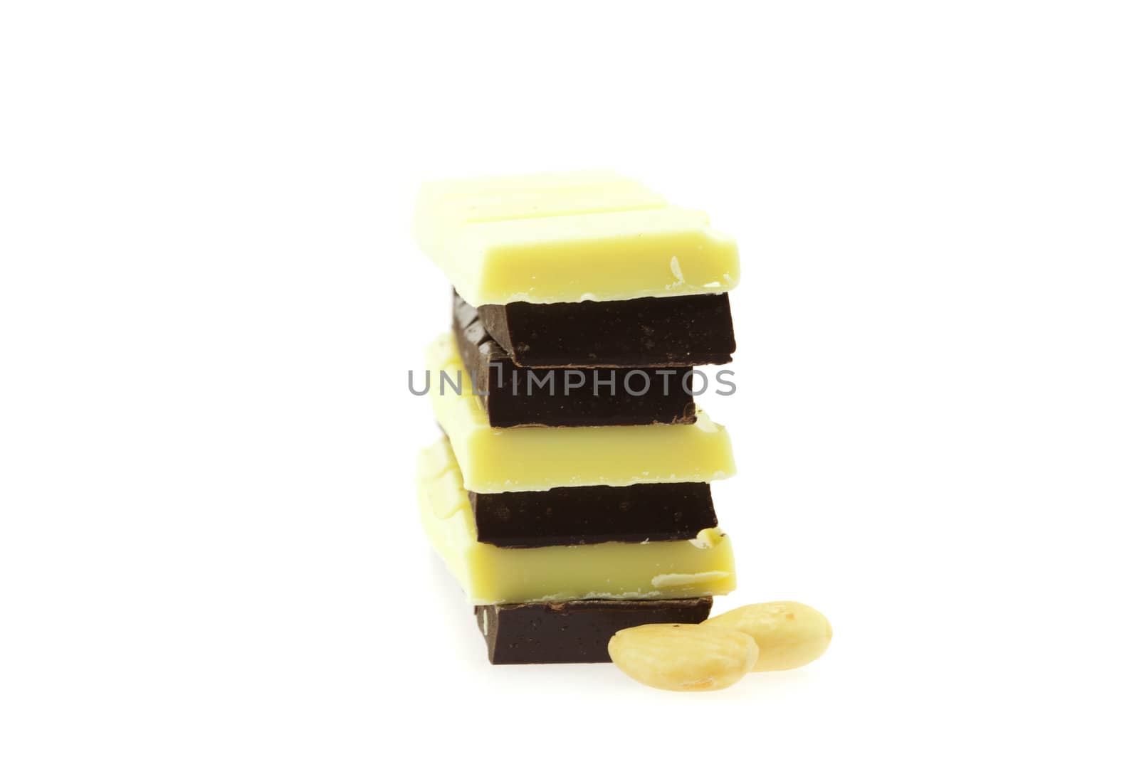 white and dark chocolate and almonds isolated on white