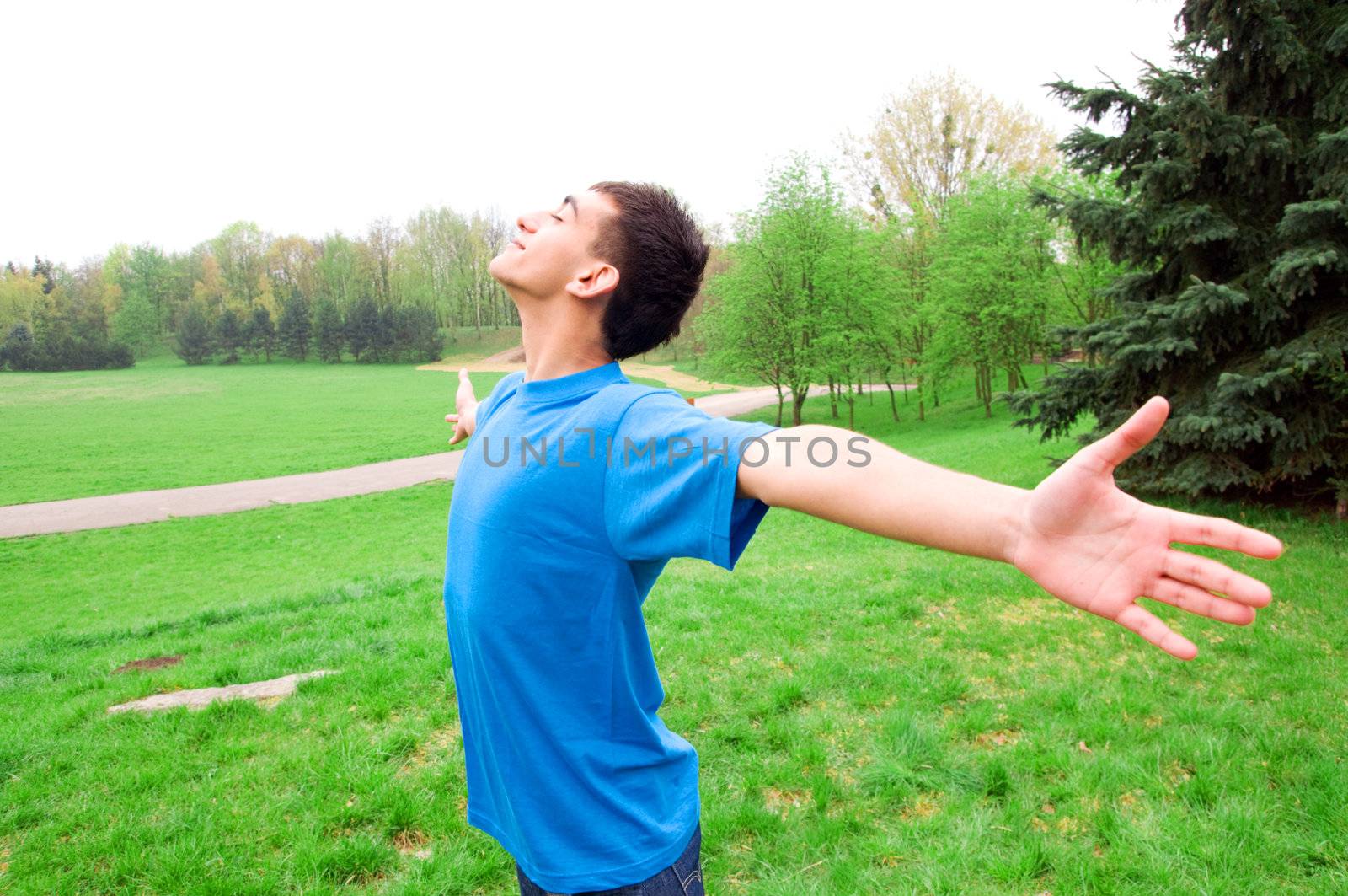 Young happy man in harmony with nature