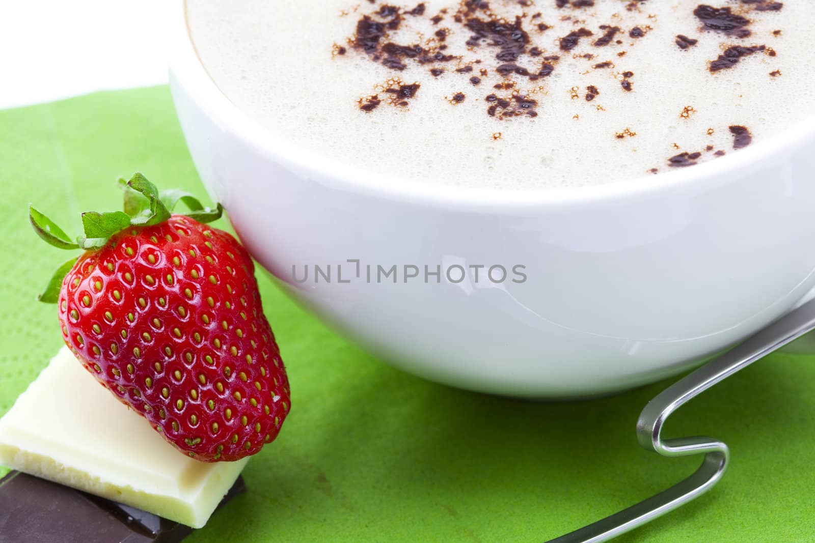 cappuccino, strawberry and chocolate on a napkin