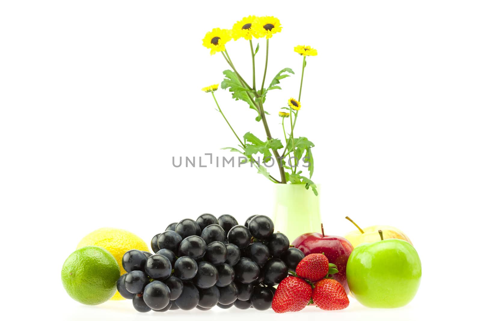 apple, strawberry, lemon, lime, grapes and flowers isolated on white