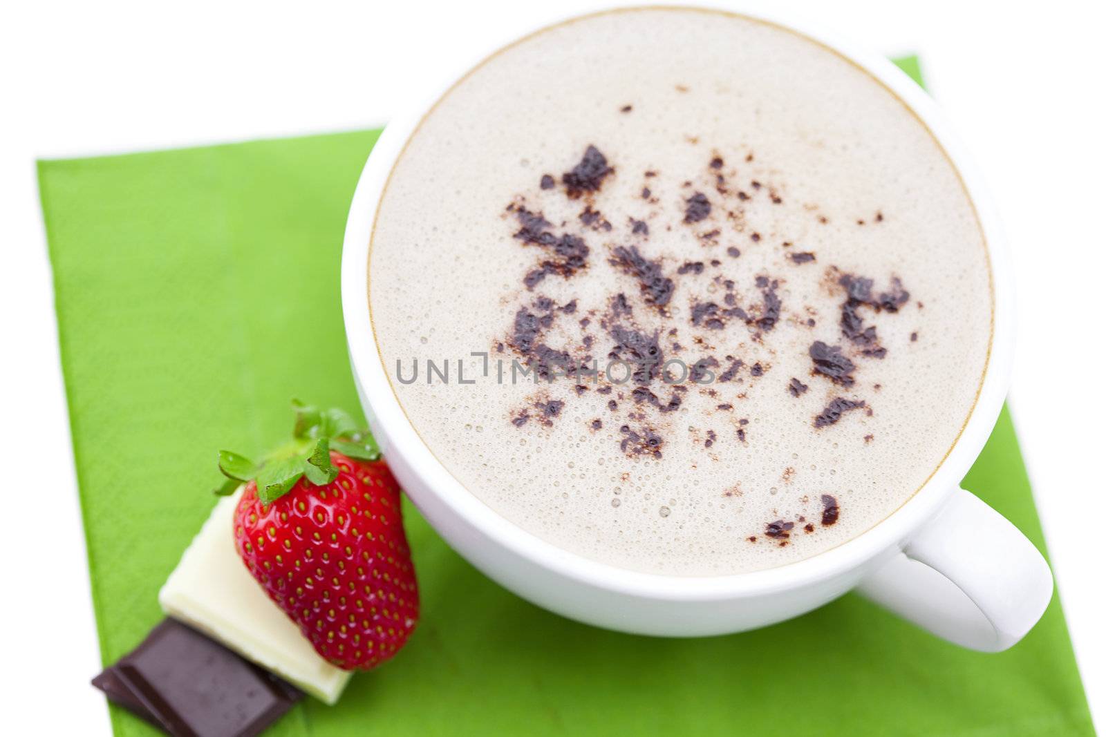 cup of cappuccino with chocolate and strawberry on a napkin