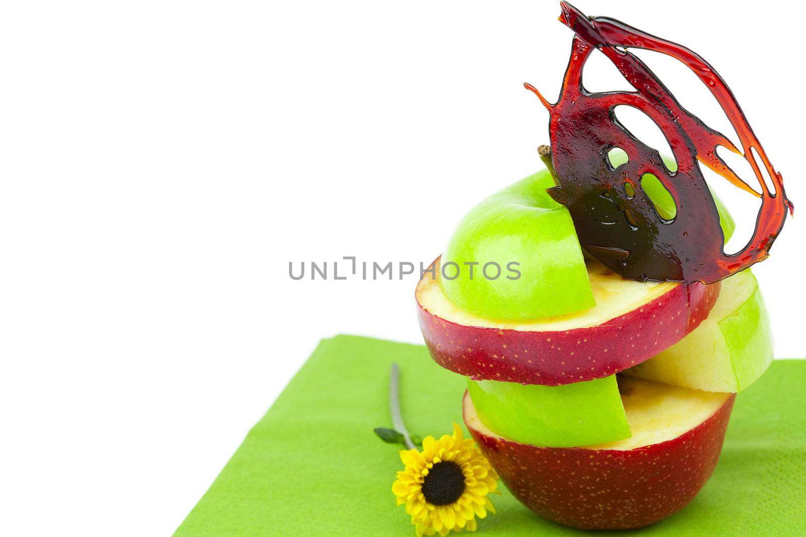 sliced apples with caramel and a flower on a napkin