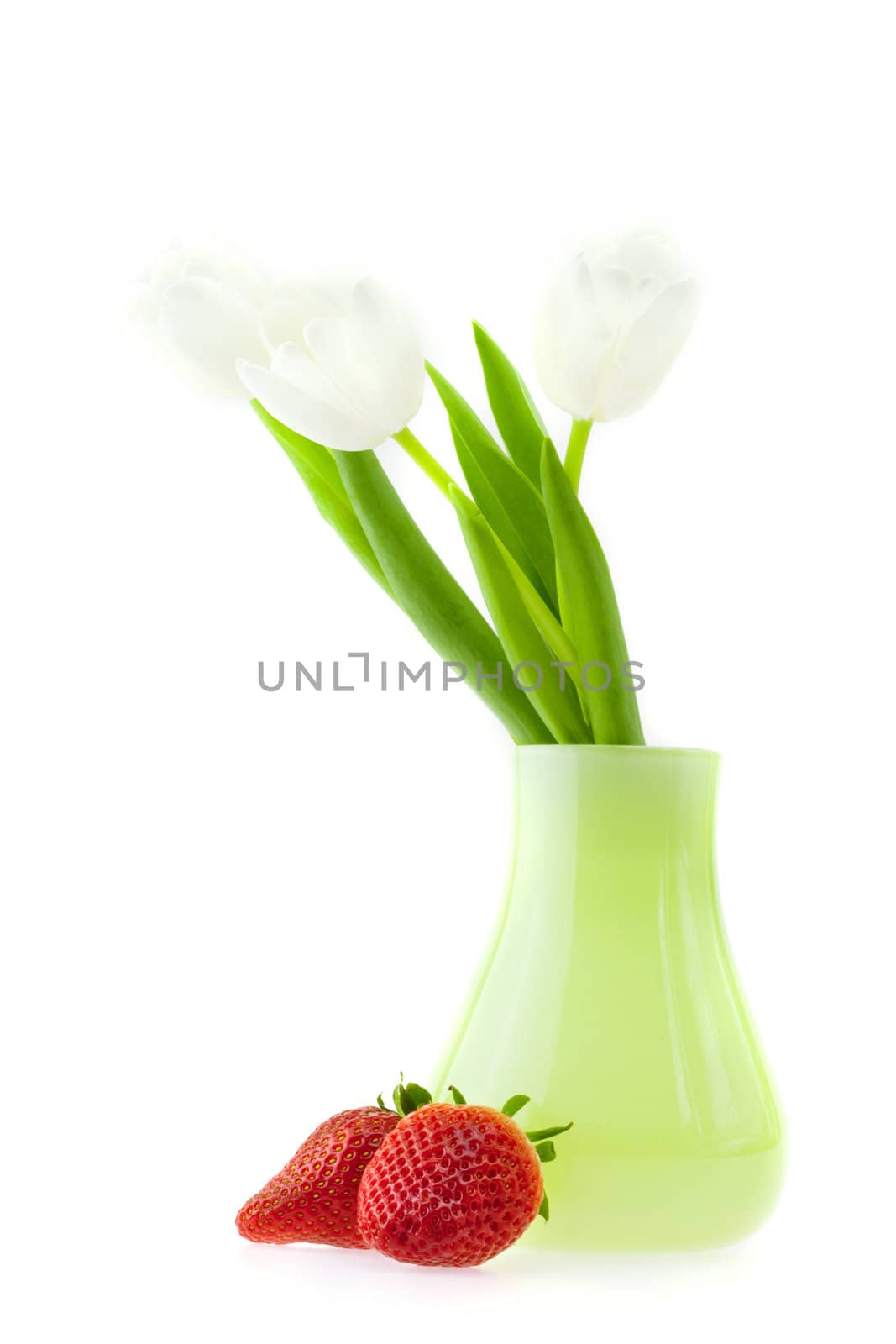 tulips in a vase and strawberries isolated on white