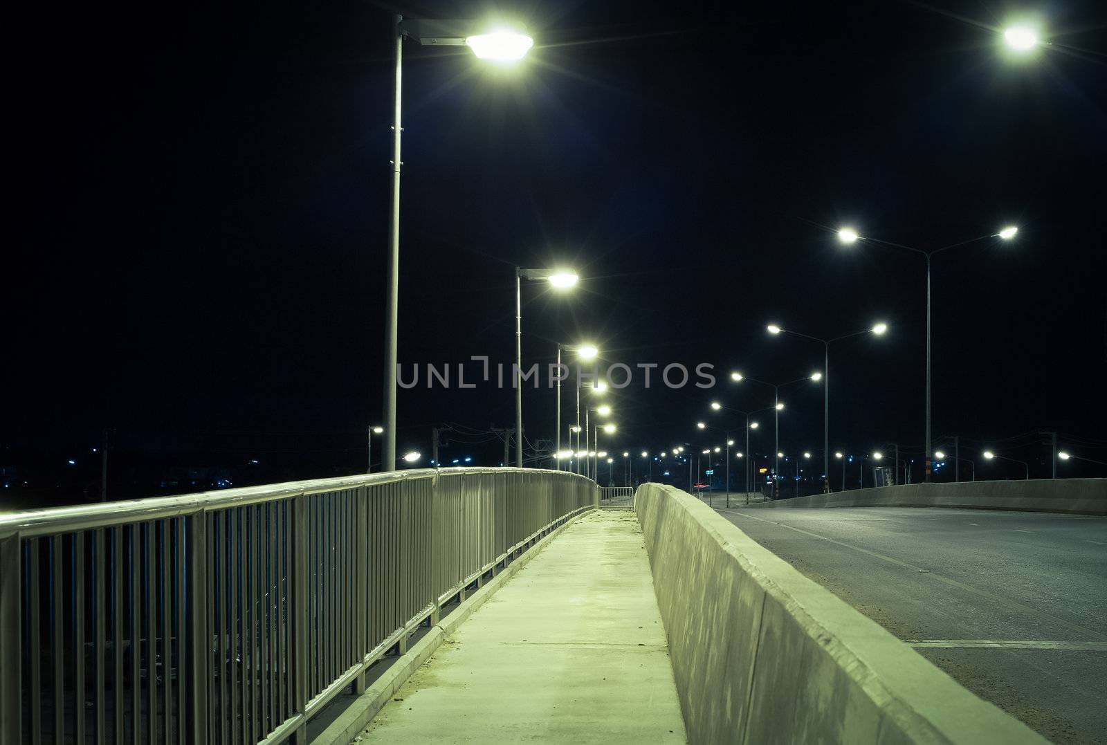walkway and road at night, safety and security concept