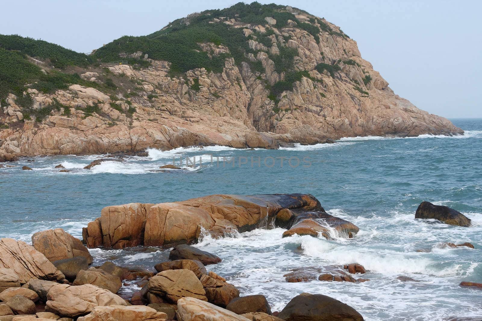 rocky sea coast and blurred water in shek o,hong kong 