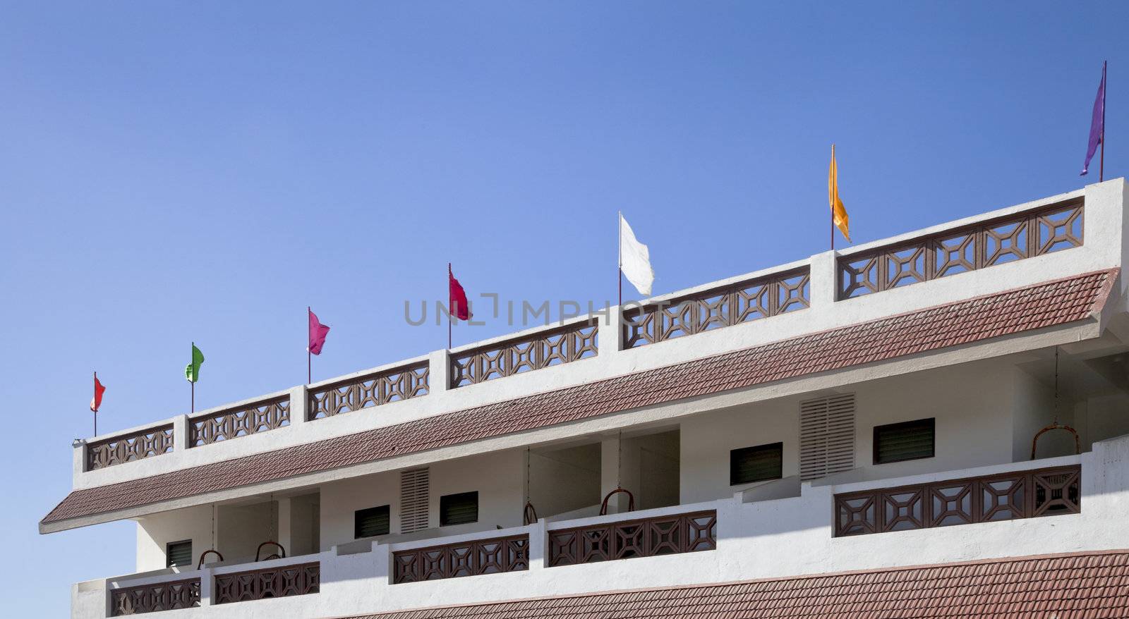 Panoramic landscape of multi colored flags waving in the gentle breeze coming off the Arabian Sea 5 kilometers outside Dwarka Gujarat India on the coastal road from Mangrol