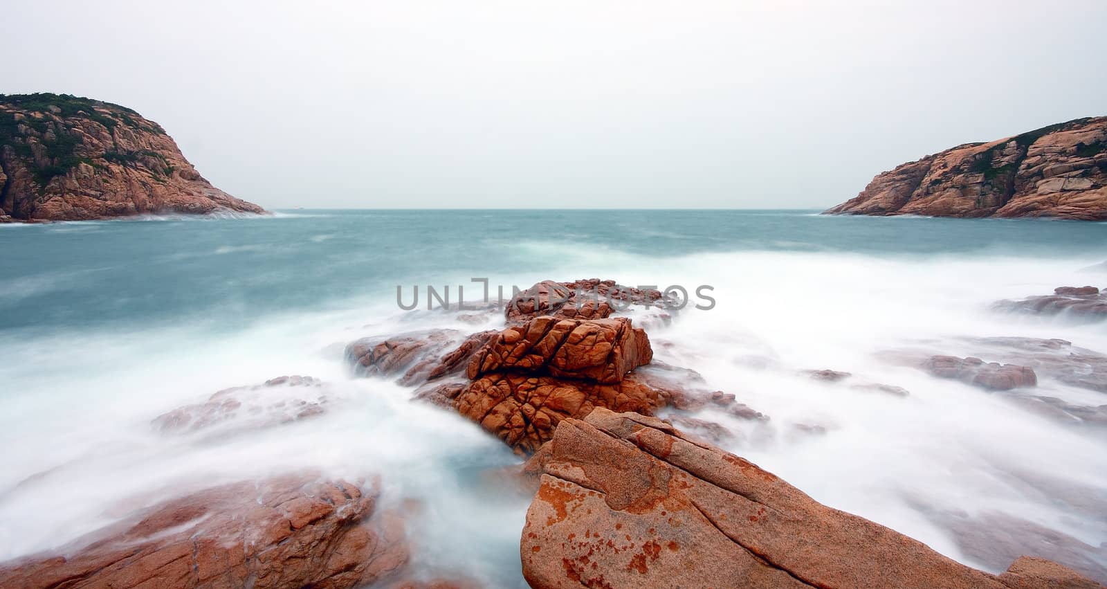 rocky sea coast and blurred water in shek o,hong kong 