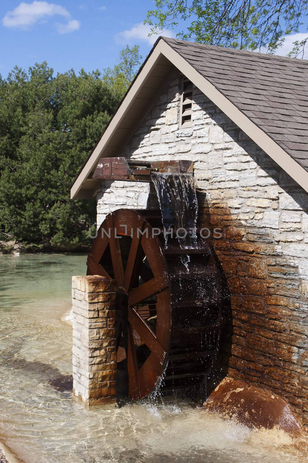Water Wheel turns as water goes over it.