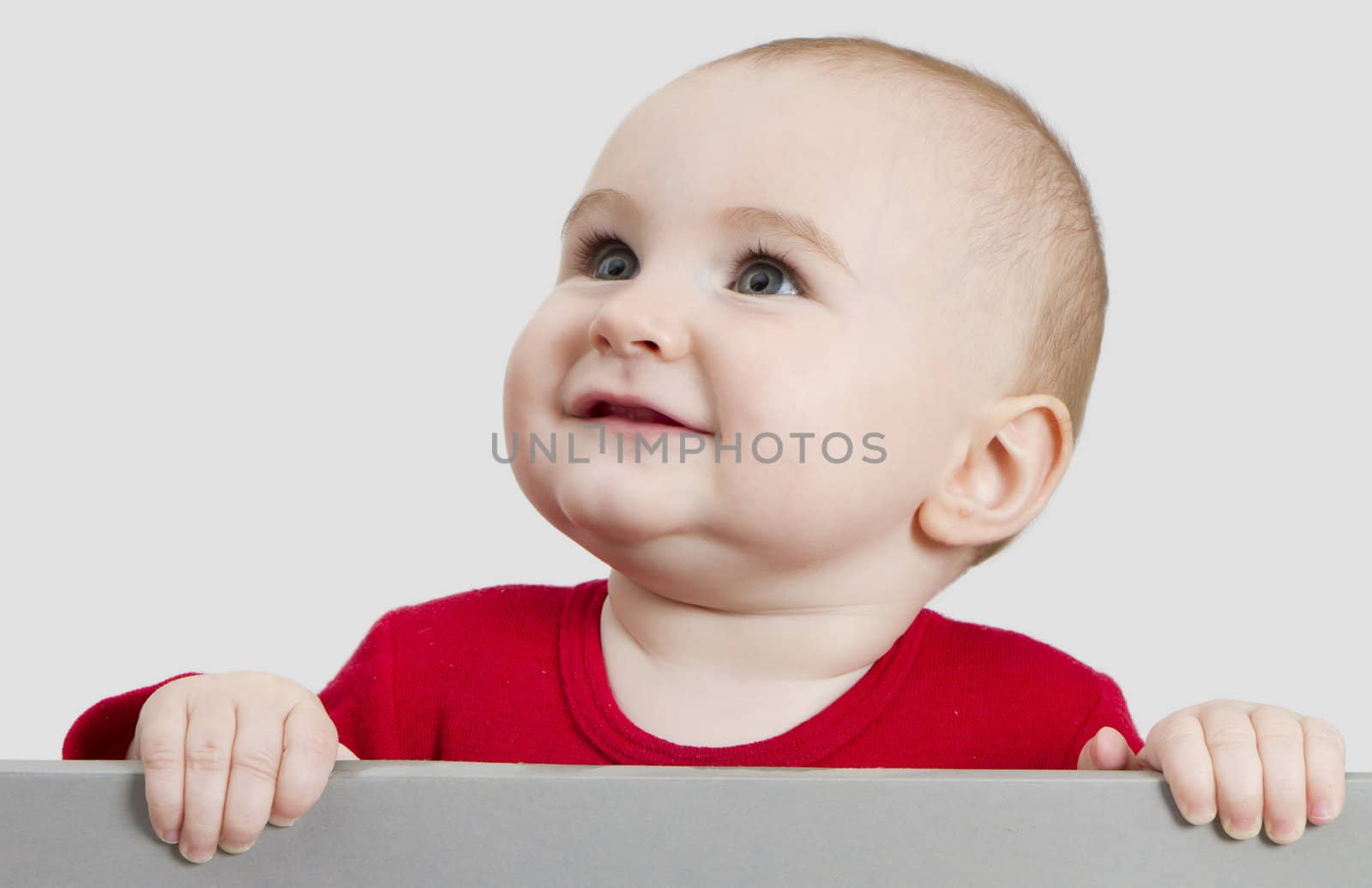 young child holding sign. isolate on light grey background